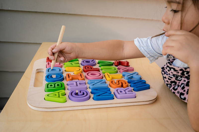 Child tracing using Kiddie Connect Take-Along Uppercase Alphabet Puzzle