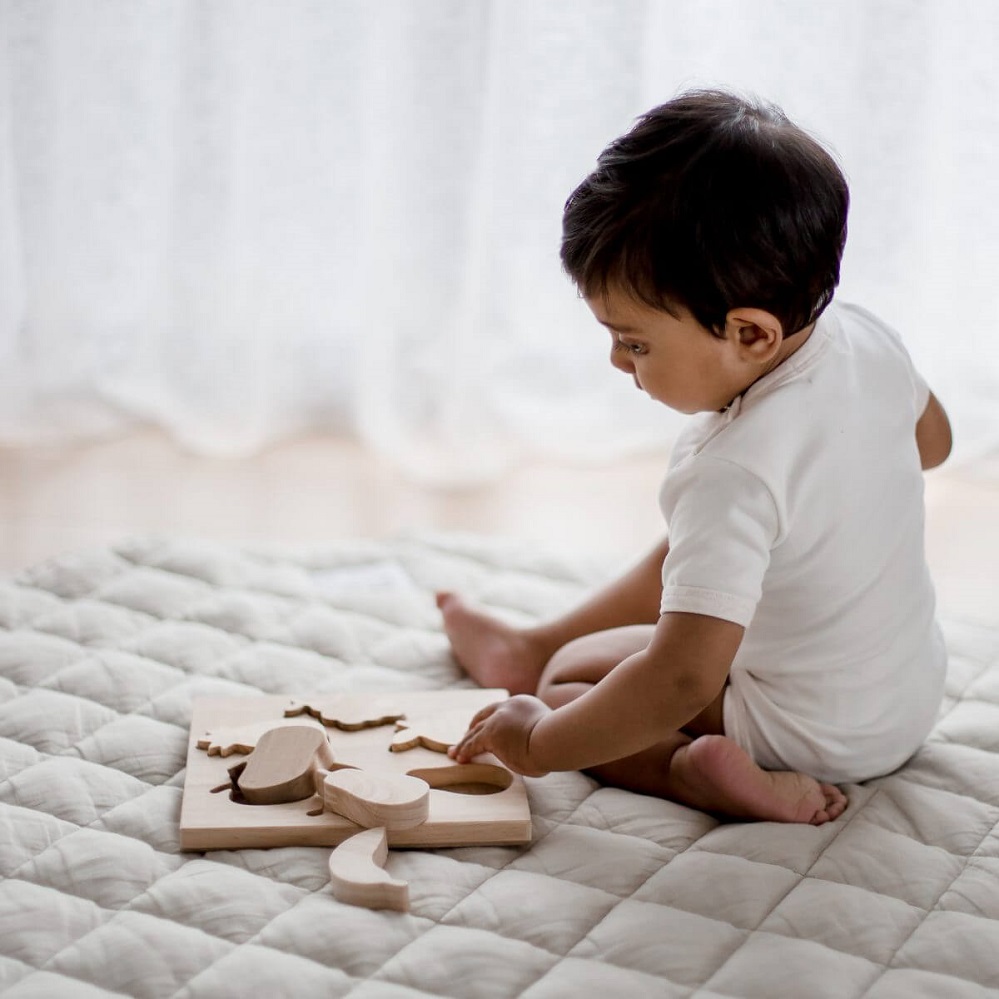 Child playing with Qtoys Fruit Puzzle Child playing with Qtoys Fruit Puzzle