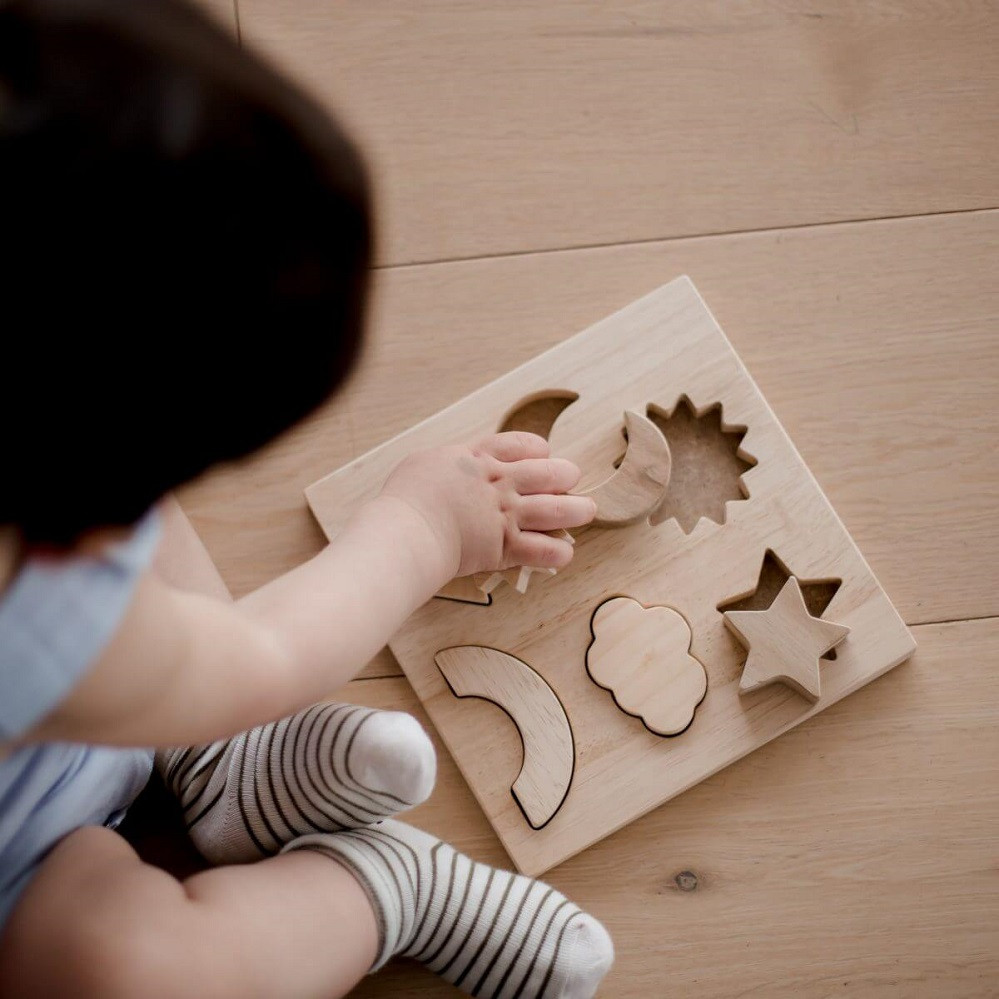 Child engaged in the Qtoys Weather Symbol Puzzle