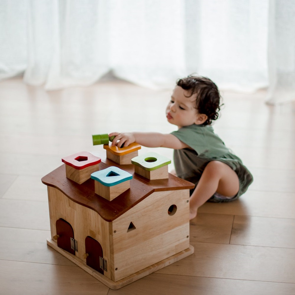 Qtoys Sorting Cottage & Play House with toddler engaged in play