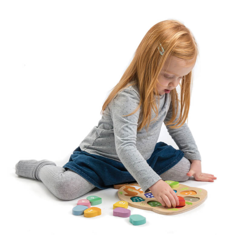 Child playing with Tender Leaf How Many Acorns Wooden Puzzle
