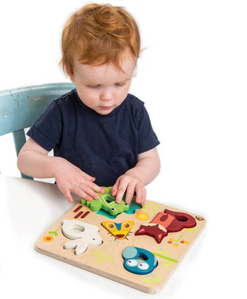 Child playing with Tender Leaf Touchy Feely Animals Puzzle