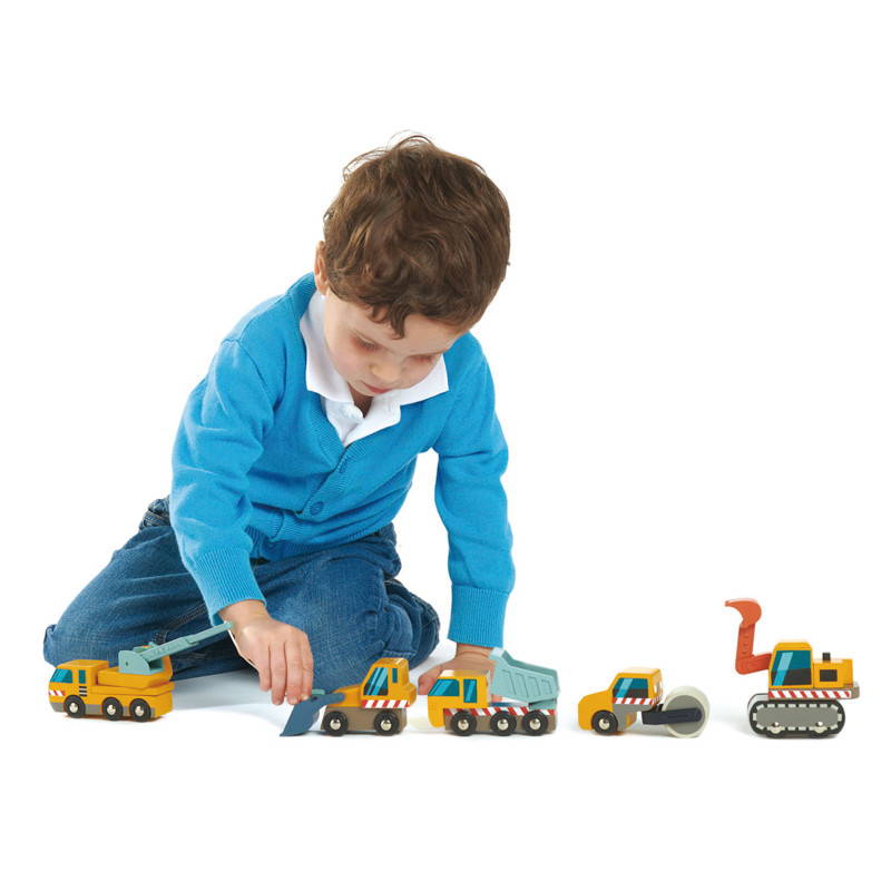 Child playing with Tender Leaf Wooden Construction Car Set