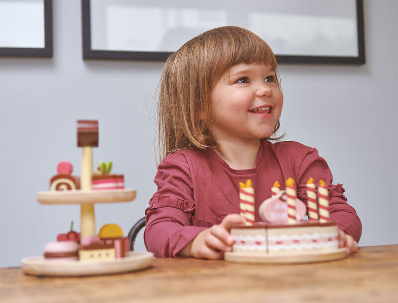 Child playing with Tender Leaf Chocolate Birthday Cake