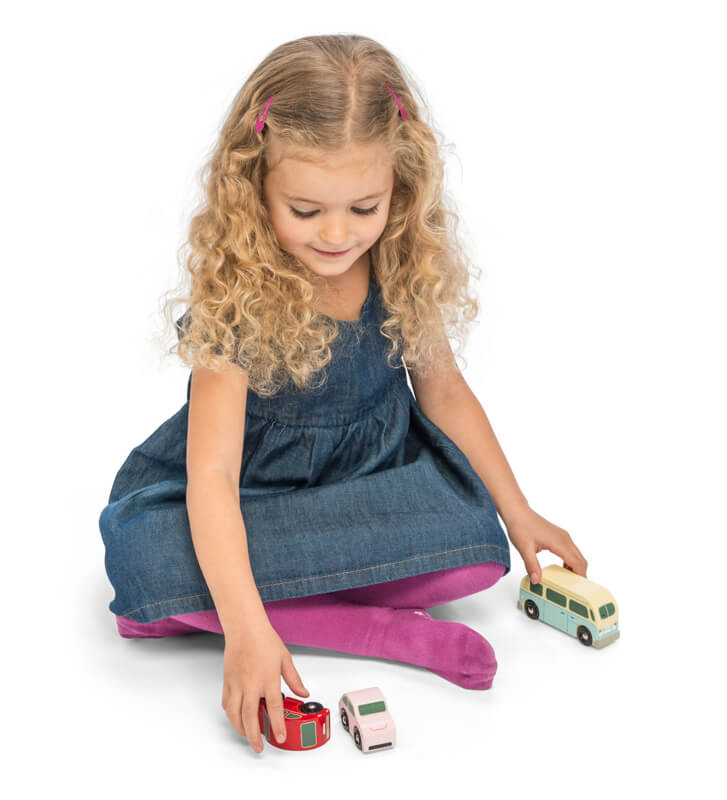 Child playing with Le Toy Van Retro Metro Car Set