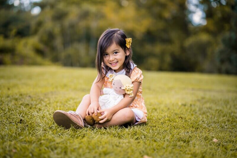 Child playing with Bonikka Priscy Linen Doll with Blonde Hair Child playing with Bonikka Priscy Linen Doll with Blonde Hair