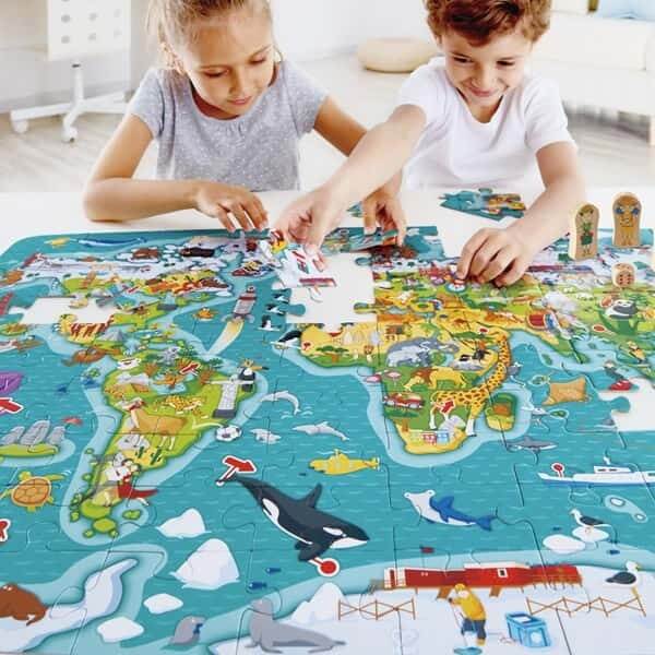 Children working together to build the Hape 2-in-1 World Tour Puzzle & Game