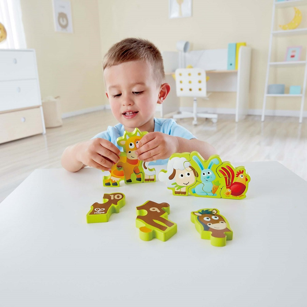 Child enjoying the Hape Numbers & Farm Animals