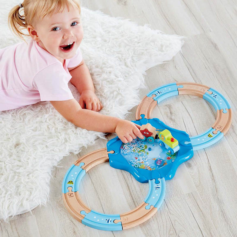 Child playing with Hape Undersea railway playset