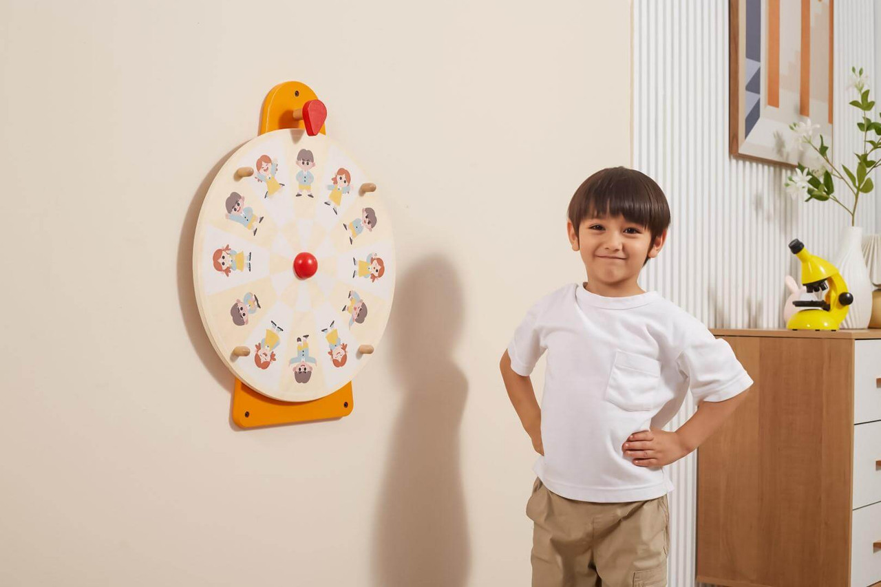 Child performing actions from Viga Wall Toy - Movement and Facial Expression Turntable