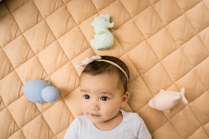 Infant with Tikiri Rubber Ocean Buddies Marshmallow Set
