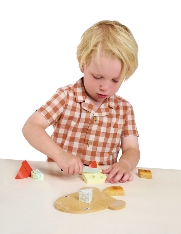 Child playing with Tenderleaf Cheese Chopping Board Set