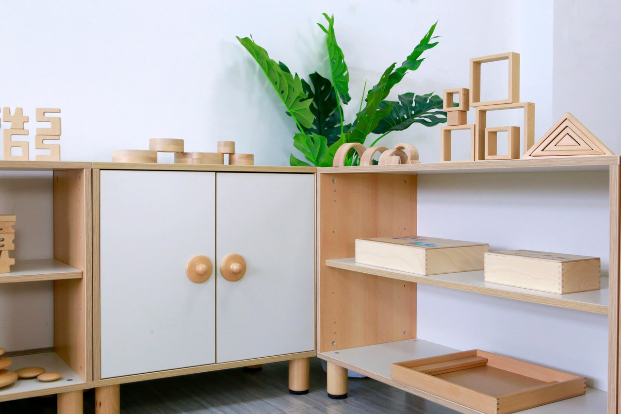 GAM Montessori 2 Tier Wide Shelf placed against other GAM shelving units