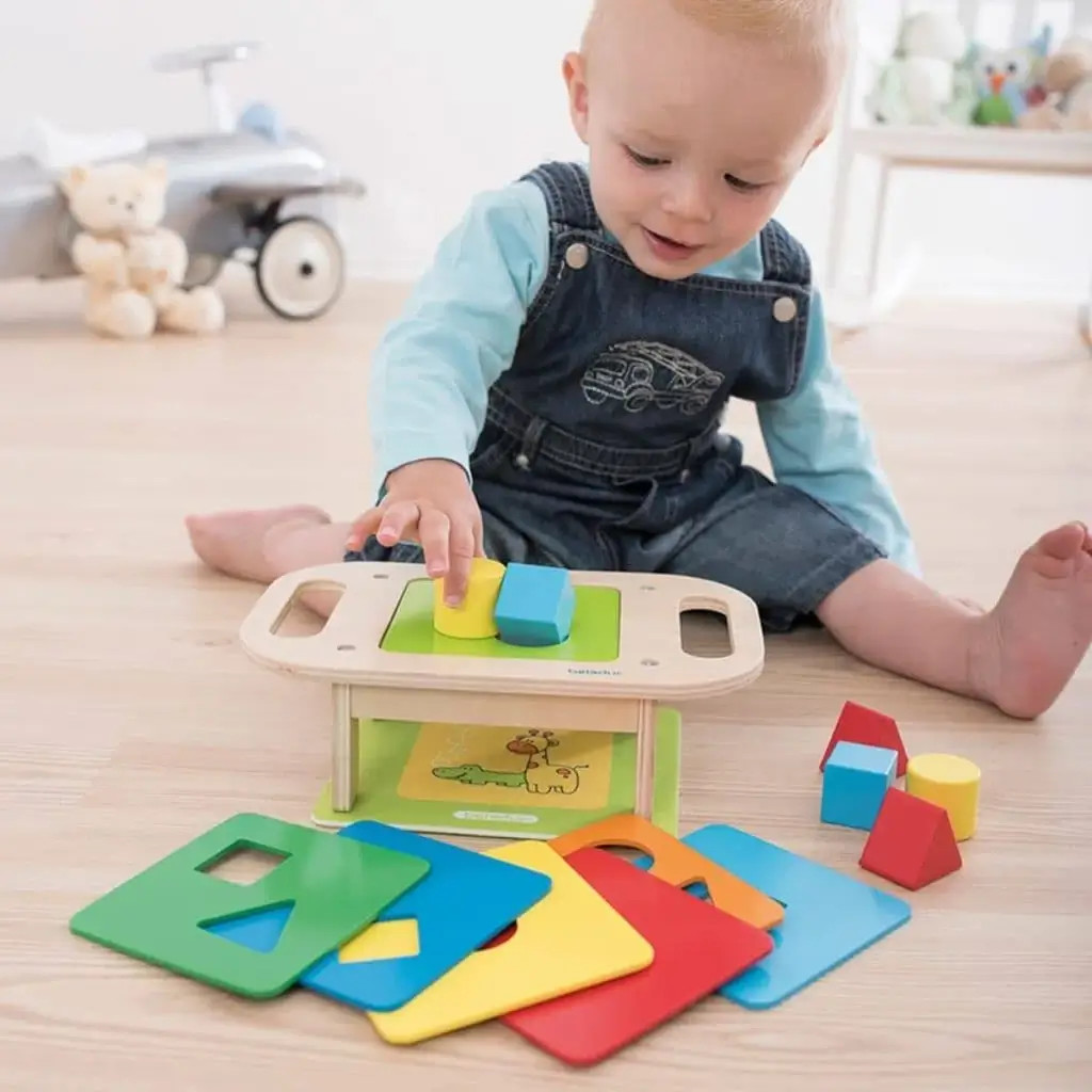 child playing with interchangeable shape sorter toy child playing with interchangeable shape sorter toy
