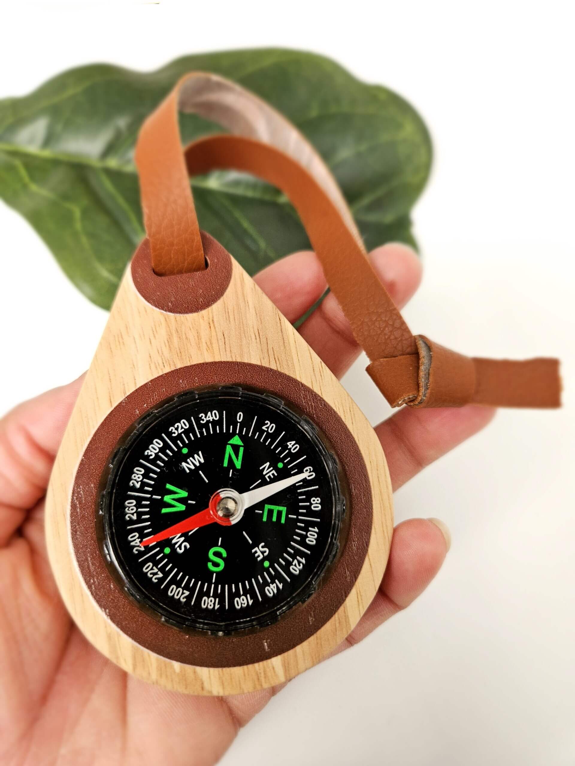 child with wooden compass for kids