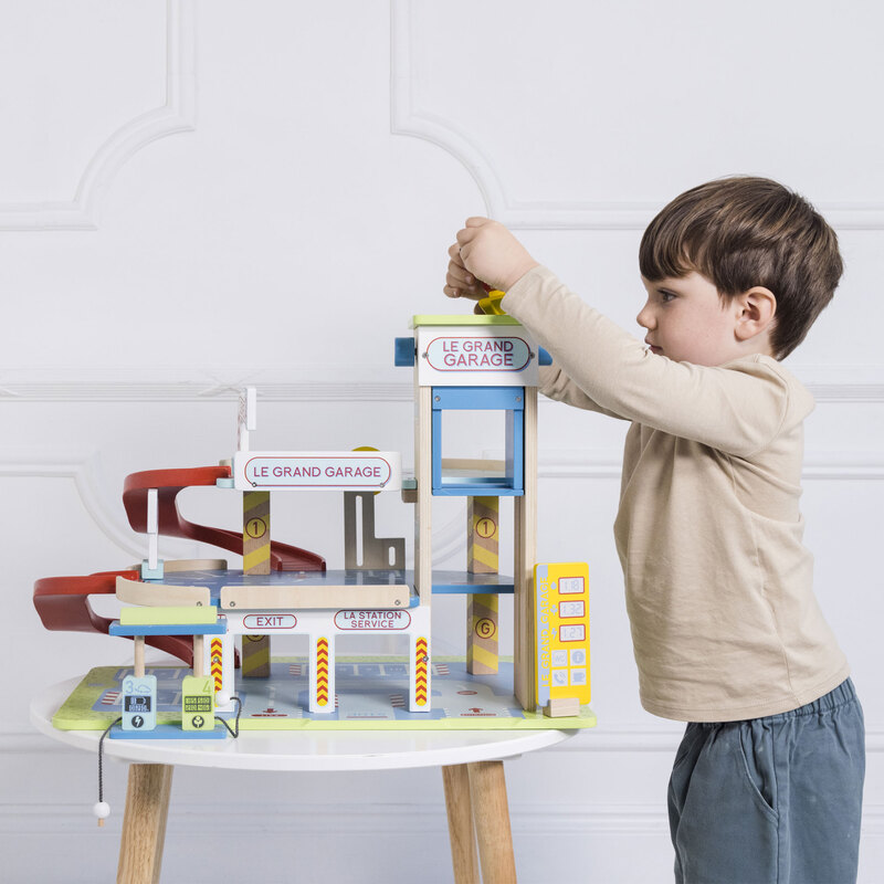 boy playing with le toy van grande wooden toy garage station boy playing with le toy van grande wooden toy garage station