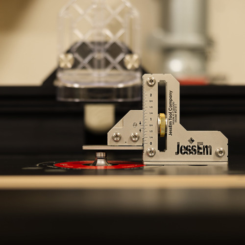 Setting cutter height with a JessEm tool setting gauge on a router table, action shot