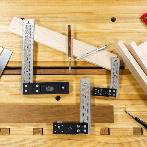 Marking a board with a JessEm stainless precision square on a workbench, action shot