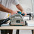 Makita SP001GZ05 plunge cut saw in action making a precise cut on wood.
