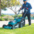 Person mowing a lawn with a Makita cordless 21-inch mower, lifestyle photo
