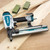 Makita AT2550A pneumatic 1 inch wide crown stapler in use on woodworking application