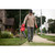 User operating Milwaukee blower on sidewalk near home