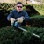 Makita DUH607Z hedge trimmer in outdoor landscaping use