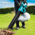 Makita blower vacuum collecting leaves on lawn