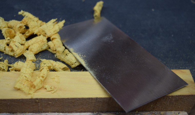 The thin, curled up ribbons from a block of quarter sawn osage orange using our scraper.