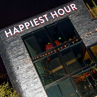 Seen in several publications for being one of the Best Happy Hours in Dallas, Happiest Hour is a popular destination located in the Harwood District. With Dallas largest patio bar and lounge, this stylish bar offers a playful club atmosphere while remaining a posh bar that offers select bites and cocktails.