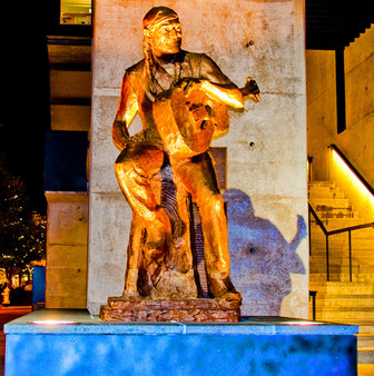 This 8-ft. bronze statue is located outside Moody Theater in Austin, Texas and depicts iconic country artist, Willie Nelson, smiling with his guitar.