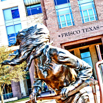 Created in 2009 and located in front of a Municipal Complex, this seven-ft tall sculpture depicts a young woman pumping water for dinner. Surely becoming a tourist attraction, this bronze statue is one full of beauty that speaks to Friscos agricultural and nature features.