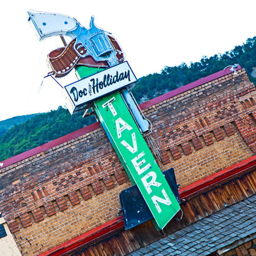 This 20 foot high pistol neon sign highlights the location of Doc Holliday's Saloon located in Glenwood Springs, Colorado. This restaurant serves lunch and dinner with a full service bar. Doc Holliday's is  a must see, featuring old west reenactments, an antique bar where Doc himself may have once sat.