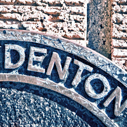 With its rustic blue and brownish tones, Dentons manhole shares the role of many others as a city focal point.