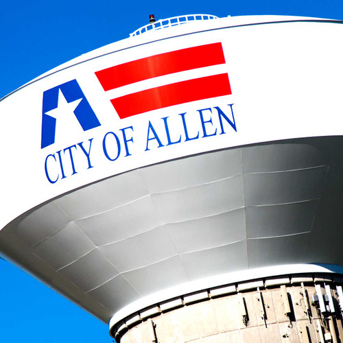 This massive water tower is located in Allen, Texas, behind the Nine Bands Brewing Company. The tower is painted white and has a stylized American flag and CITY OF ALLEN painted on it.