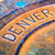 This image highlights the word Denver on a distressed city manhole cover. This image highlights the word Denver on a distressed city manhole cover.