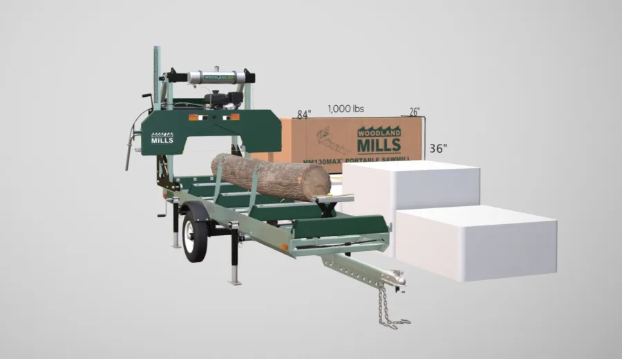Woodland Mills HM130MAX trailer sawmill with a log loaded, beside its shipping crate