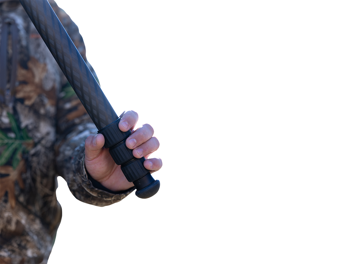 Close-up of a hand pulling a magnetic leg angle tab on the Benchmark tripod, with a second detail of a hand on the BH-40 main knob and tension knob