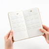 Hands holding the Making Memory Handy diary open to the 2027 and 2028 yearly calendar spread.