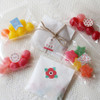 Goody bags decorated with unique shape paper stickers
