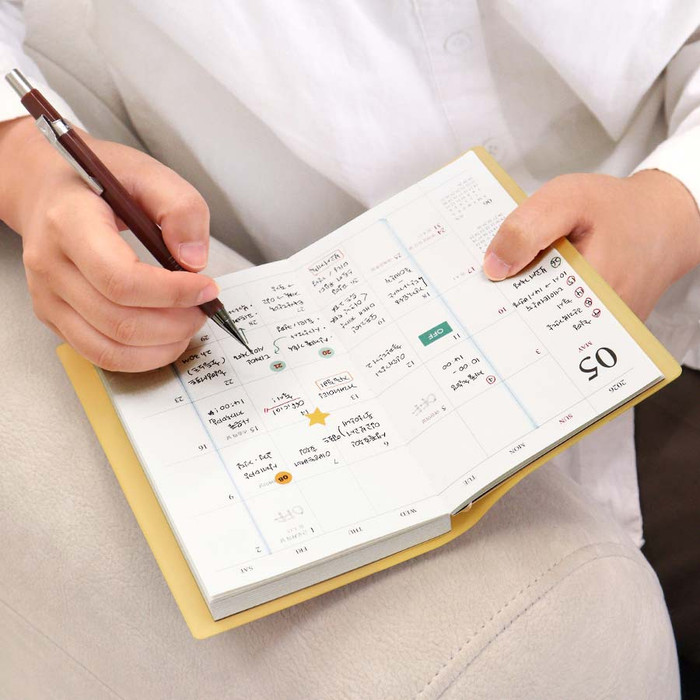 Official Slim Dated Planner in a stylish flat-lay with accessories.