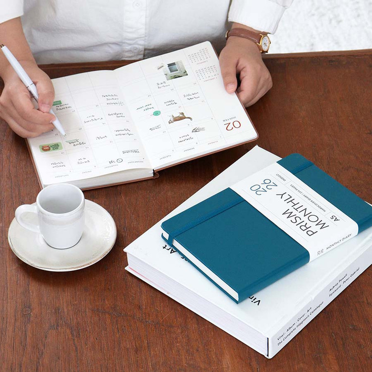 An aspirational lifestyle photo showing the planner on a clean, organized desk, representing a life of calm productivity.