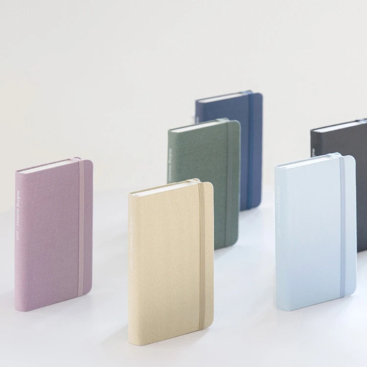 Byfulldesign 2027 Making Memory Handy daily diaries standing upright in six fabric cover colors with elastic closures.
