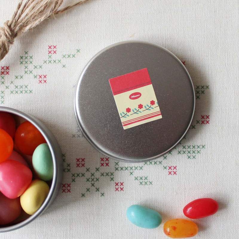 Round tin container decorated with a retro paper sticker