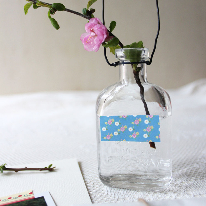 Glass vase decorated with blue floral paper sticker