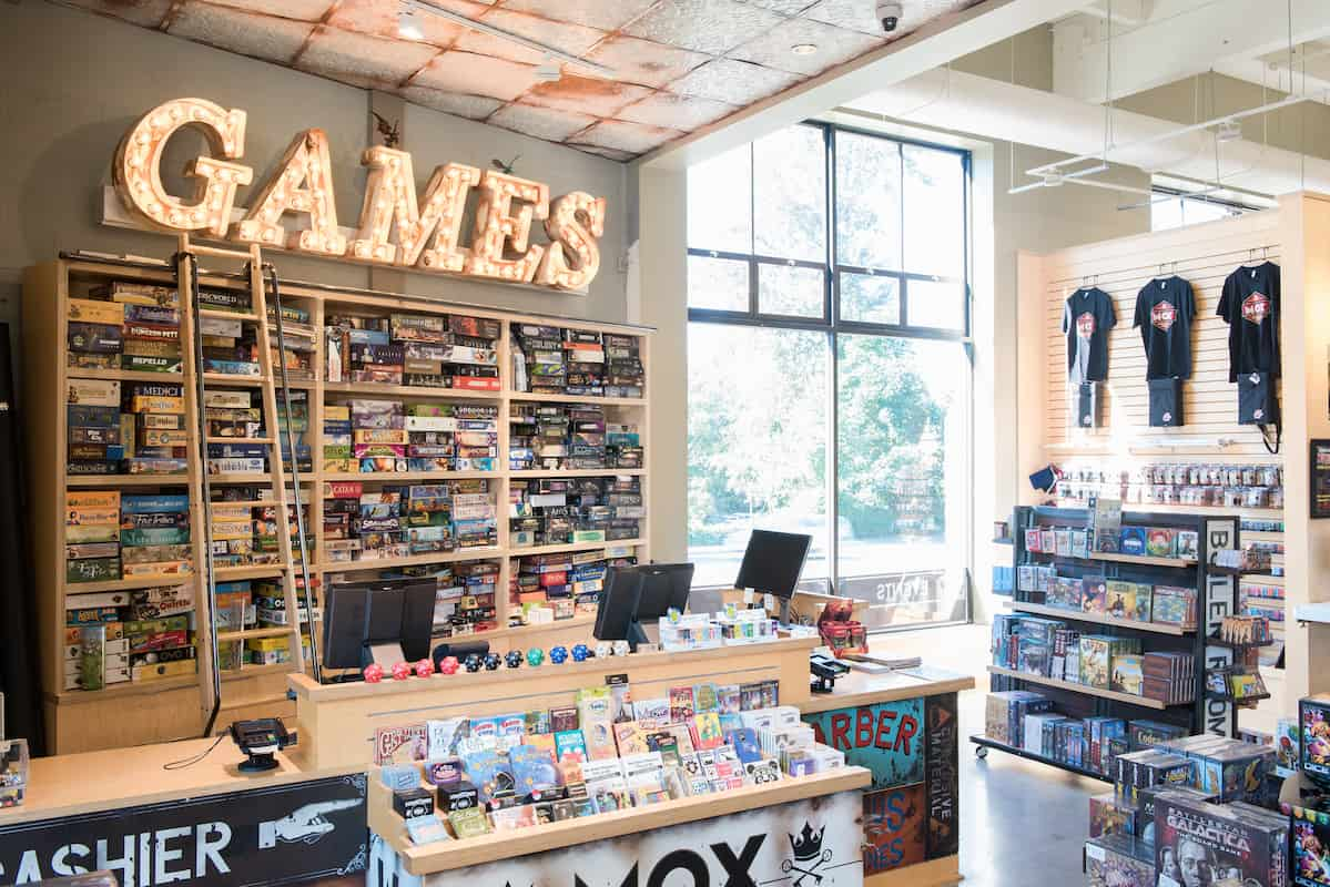 Mox Bellevue board game library and large games sign over the register