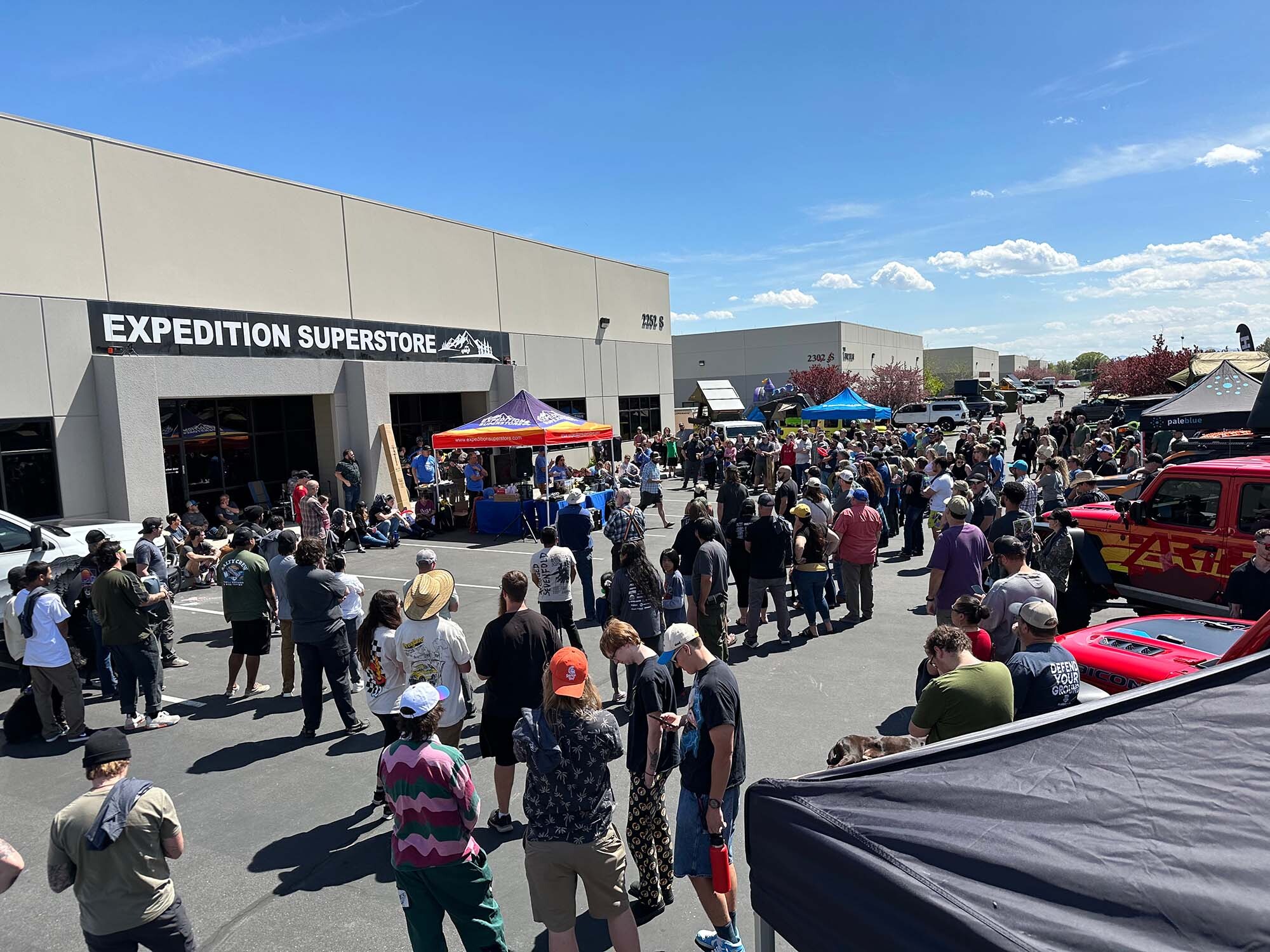 Crowds attending Expedition Superstore Trunk or Treat 2024 in West Valley City with families, kids in costumes, and decorated vehicles