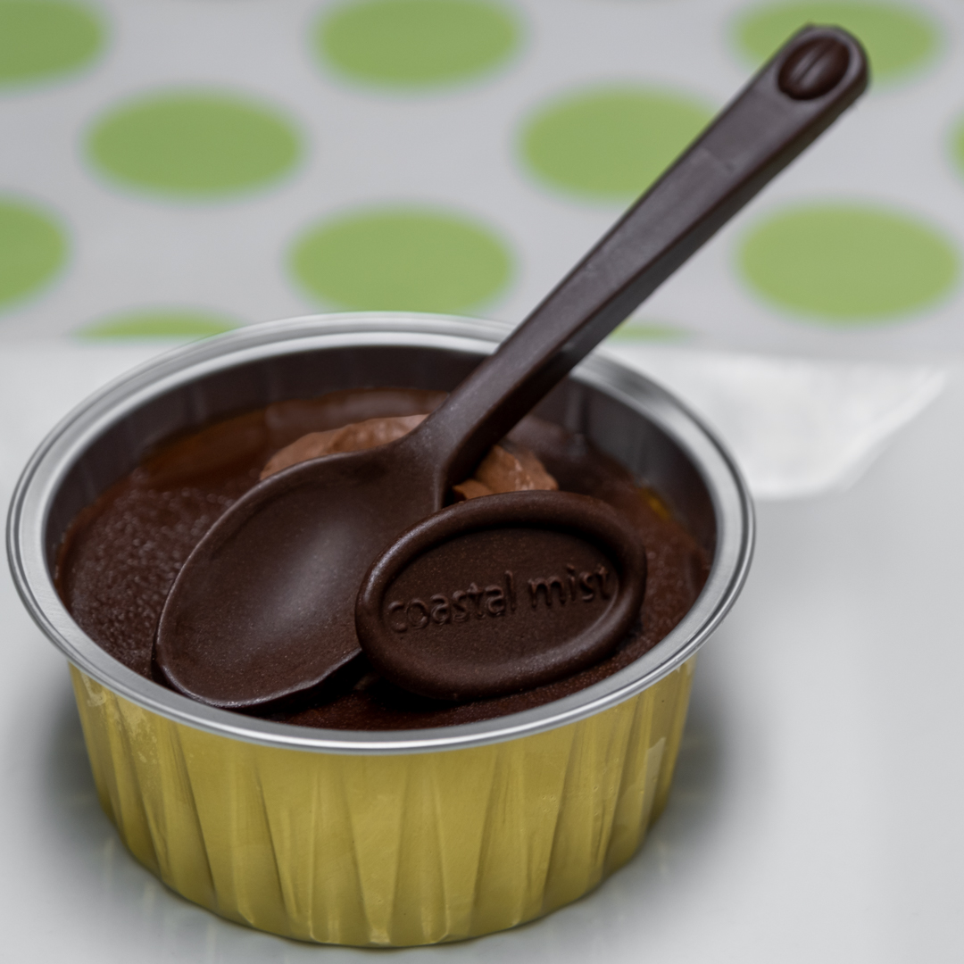 Our handmade Butterscotch sauce is topped and baked with a butterscotch custard. We then top it with our dark chocolate glaze, chocolate whipped cream and a dark chocolate spoon.