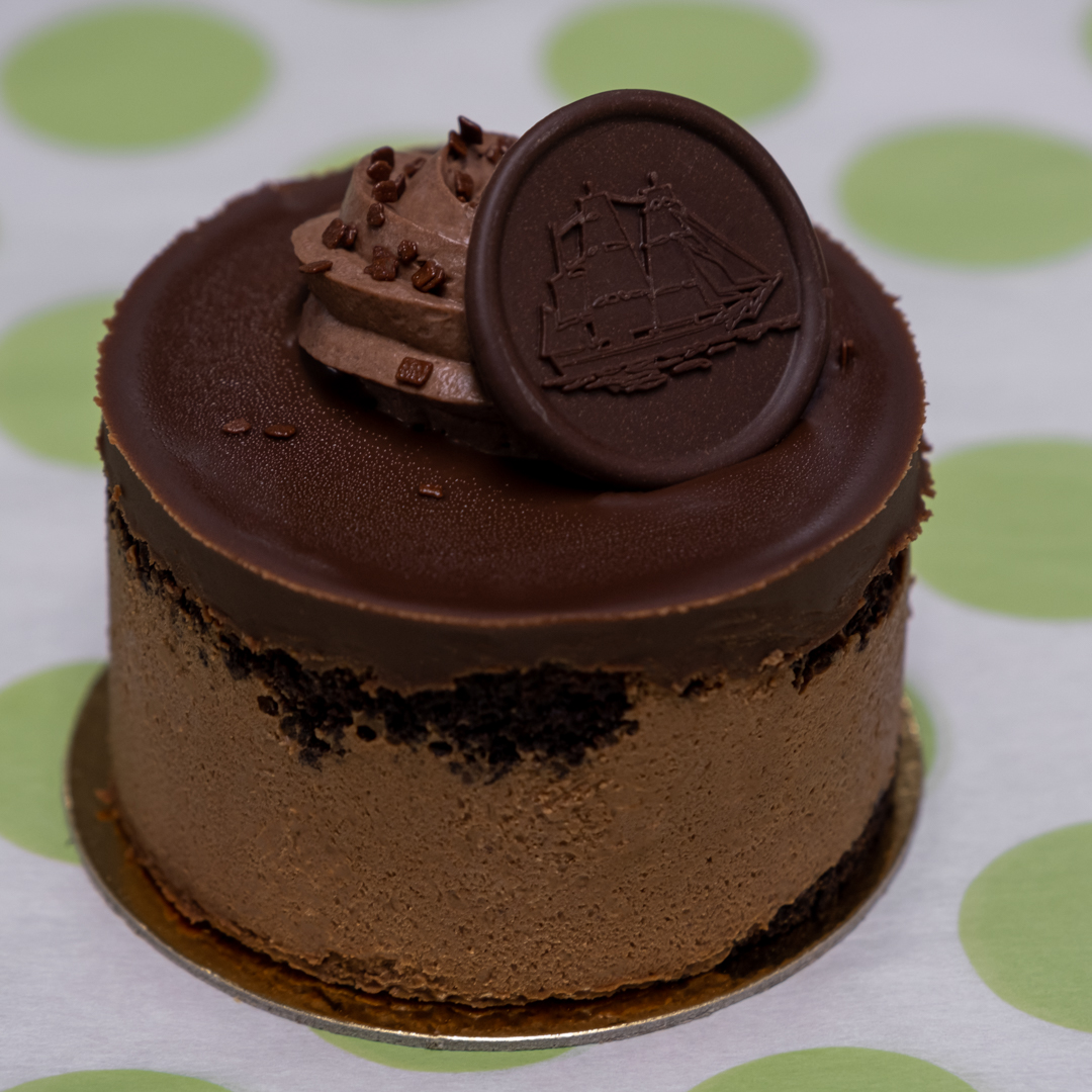 wo layers of dark Devil’s food cake are filled with a layer of dark Chocolate Mousse. This is then  topped with dark chocolate glaze and chocolate  whipped cream.