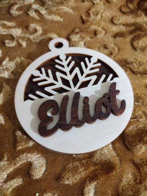Picture features a half a snowflake with a Custom Name Elliot on top.